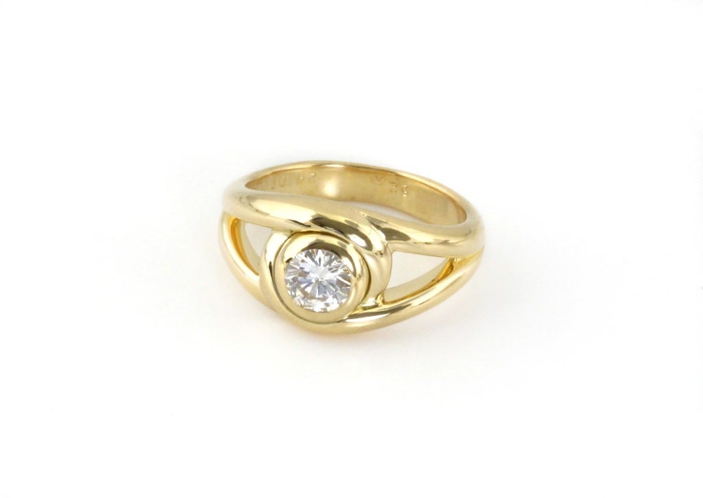 This is a tasteful, warm diamond ring. The two gold bands curve around the diamond. Almost like they're hugging it. It also looks like an eye. There's a lot of subtext in this Cartier ring. It would make a great engagement ring, or a special