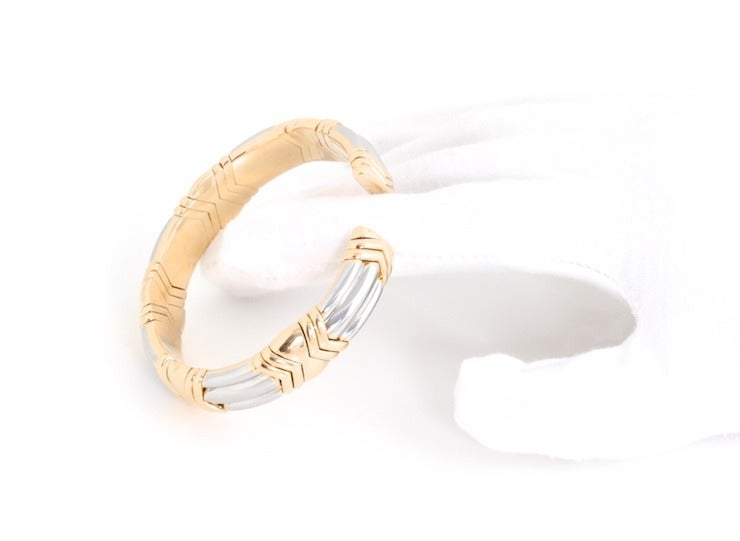 This is a heavy, modern bracelet from Bulgari (Bvlgari if you're fancy). It looks like a solid bangle, but it actually has a slit, and the bracelet is flexible so it's easy to get on, but still very secure once it's on. If you like bangles, but want