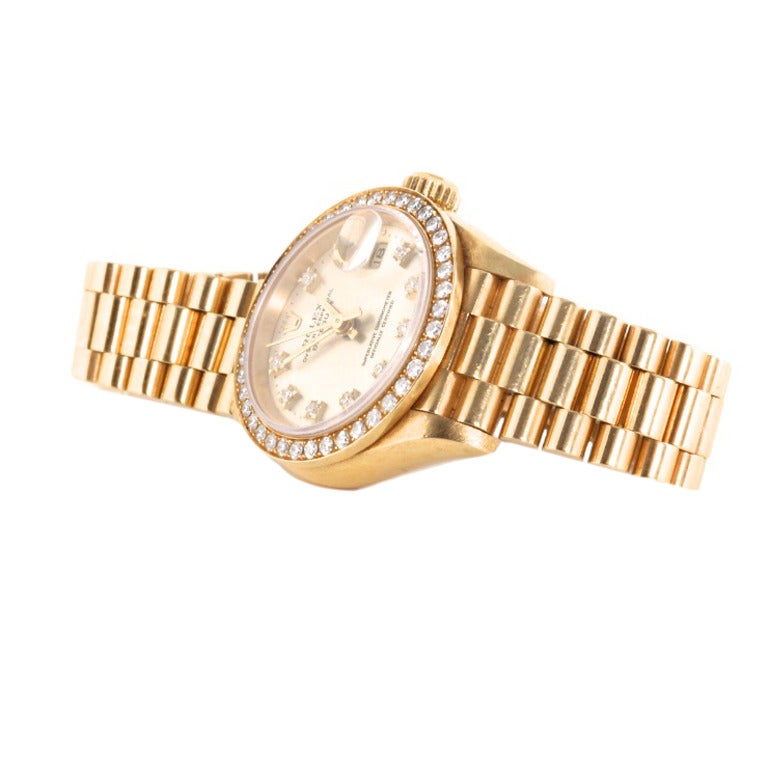 This is a Christmas gift that isn't kidding around. It's an 18k yellow gold Rolex with one carat of diamonds on the bezel. The diamonds are all original from Rolex. This is a classic diamond Rolex that will never go out of style. We will supply it