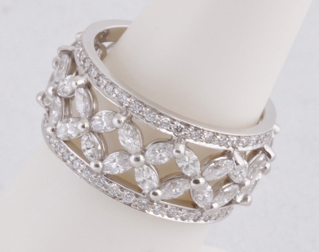 Marquis and round white diamonds come together in a gorgeous and feminine design in this stunning ring from the masters at Tiffany & Co. This is the Victoria Band Ring and it is in EXCELLENT Condition and it retails for $15,100 dollars. We are so