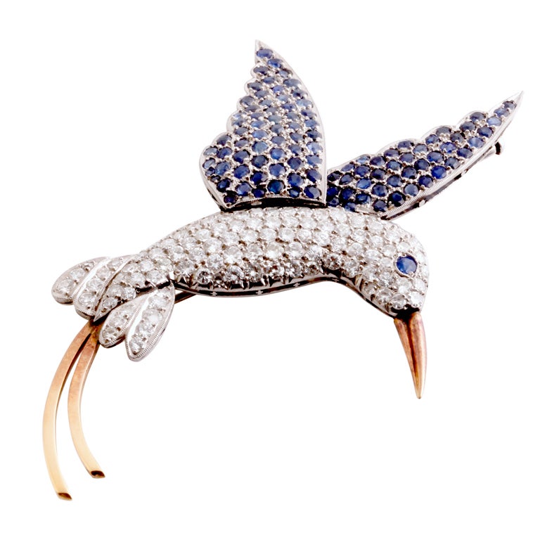 The beak and the tail of the hummingbird are 14k yellow gold and they have a lovely copperish hue to them. The rest of his body is crafted out of our favorite metal on earth: platinum. It's not only in excellent condition but it exemplifies