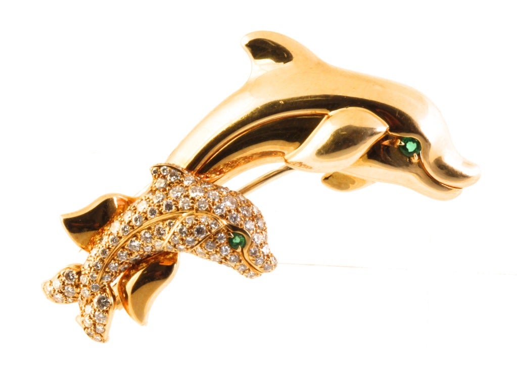 Cartier has created a parent and child dolphin. This would make a great heirloom to hand down from mother to daughter. Whimisically, yet elegantly designed as a polished-gold dolphin accompanied by a small pavé-set diamond (approx 1.00 carat)