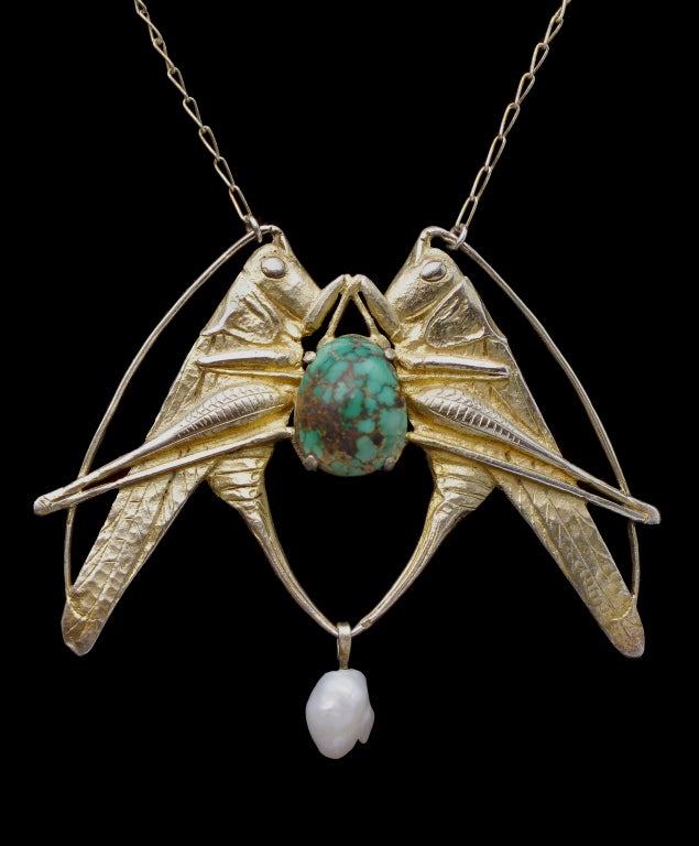 An impressive pair of grasshoppers supporting a turquoise matrix cabochon. Powerful Art Nouveau motif used by such designers as Lalique. The grasshopper symbolises a carefree approach to life.
Illustrated: Maurice Daurat. Orfèvre et sculpteur Art