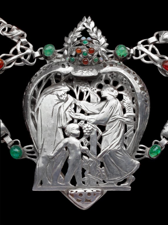 Frances Thalia How (exhibited 1896-1928) & Jean Milne (exhibited 1904-1917).
An Important Livery Collar exhibited by the Eager Heart Company. The elaborate mantle of laurel leaves surmounts a pierced inscription 'Eager Heart' 1907. The other seven