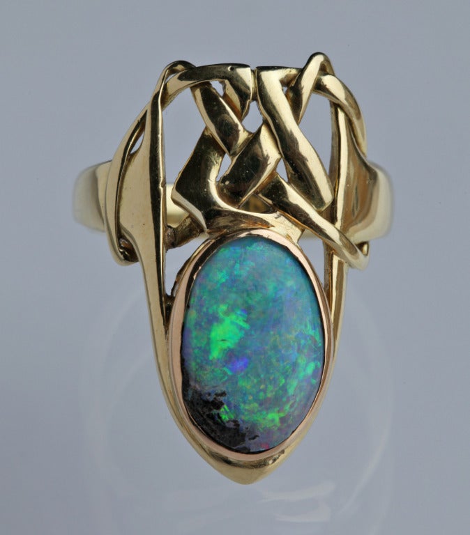 An important & previously unrecorded fabulous Liberty & Co Ring designed by Archibald Knox.
Gold with a beautiful boulder opal. 
Original fitted case the silk marked:
LIBERTY, LONDON PARIS, BY SPECIAL APPOINTMENT
H: 2.7 cm (1.06 in) 
Ring Size: