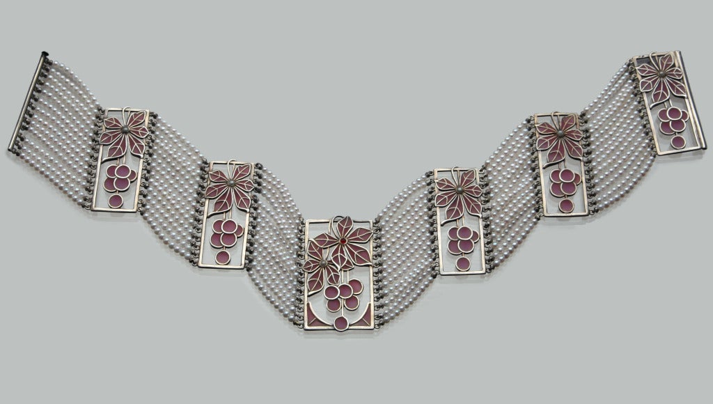 Collier de chien by Hermann & Speck, Pforzheim 
Strung with thirteen rows of pearls accented by six plique-à-jour enamel panels representing cherry blossom & cherries
Would make a wonderful gift for a bride