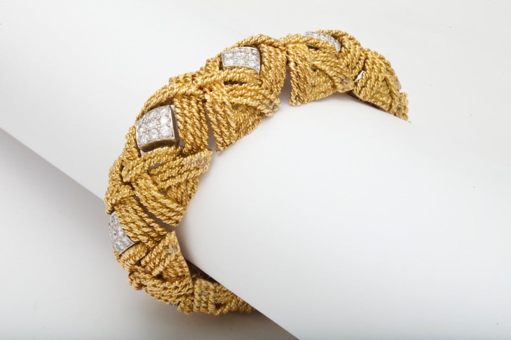 DAVID WEBB Diamond Woven Gold Bracelet
The bracelet has approximately 6 1/2 carats of diamonds set in platinum within an 18K gold frame. Gross weight is approximately 134.70 grams.