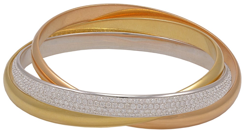 An impressive Cartier Tri-Color Diamond and Gold bangle bracelet. This jewel contains french marks.