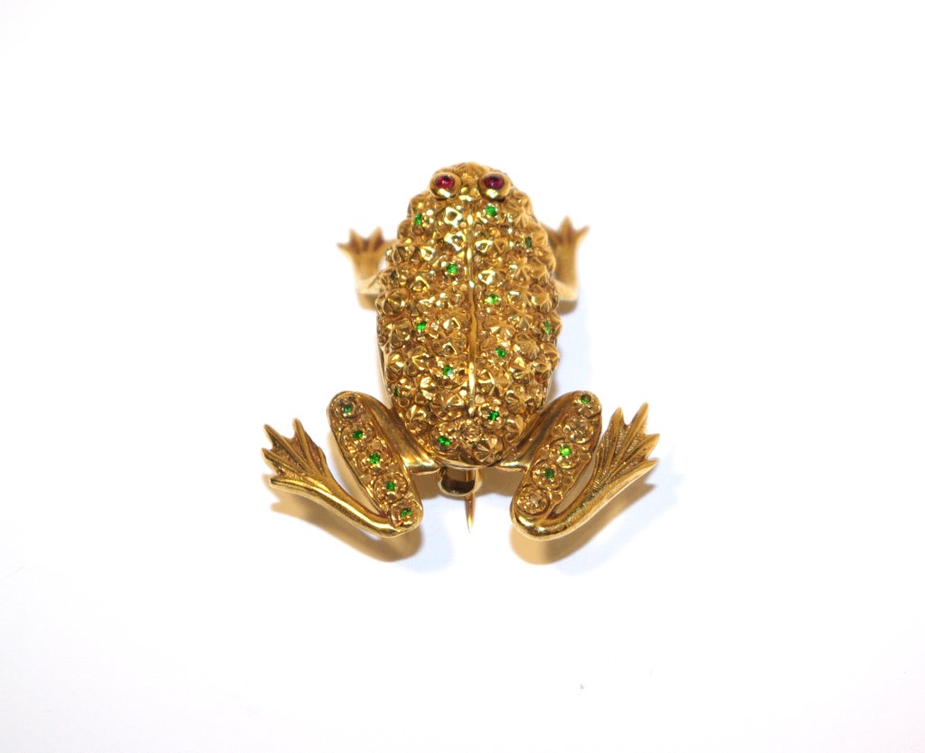 A Victorian 18 carat yellow gold fine model of a frog.  Its back and lower legs are set with small demantoid garnets within the gold settings and cabochon cut ruby eyes.

Anthea A G Antiques Ltd
155, Grays Antiques Centre
58 Davies