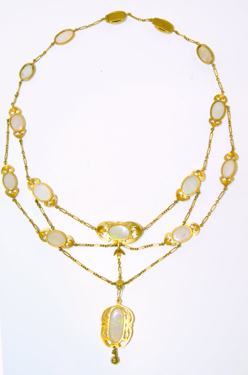 18 carat gold unsigned Art Nouveau necklace containing 17 opal in their original setting with a natural pearl drop and a small pearl in between the central drop.
It is approximately 20 inches long, and all the opals are perfect with no crazing in