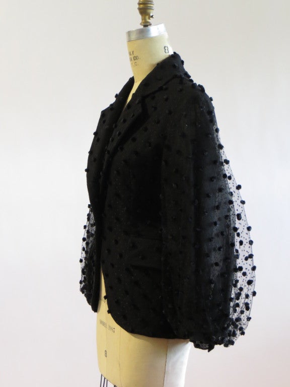 A point d'esprit and tulle with appliqued pom poms with silk lining and black jet buttons evening jacket