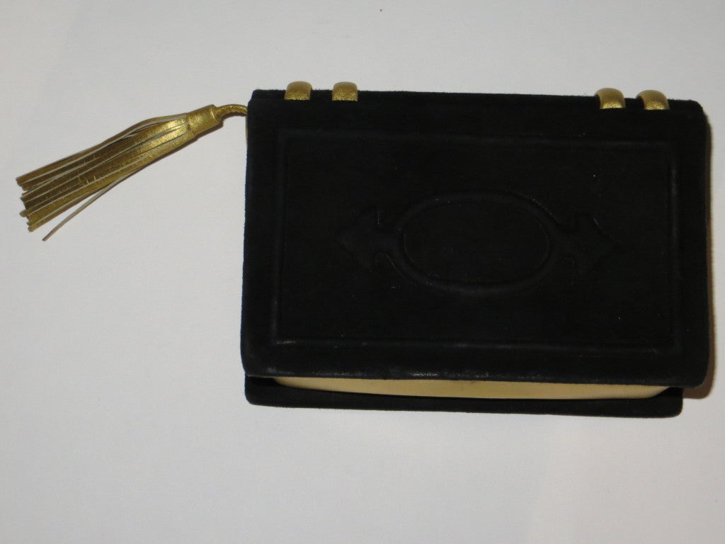 Paloma Picasso book style black suede with gold leather details evening bag. Can be used on the shoulder with the shoulder strap.