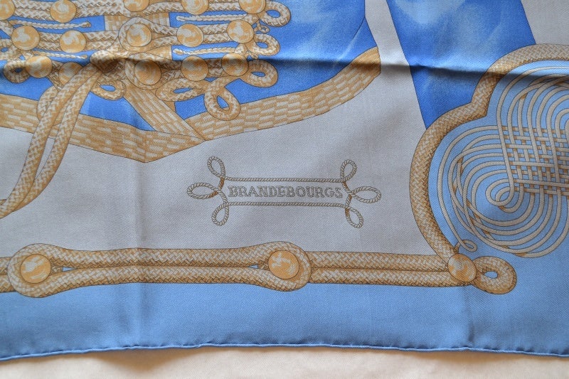 Hermes scarf Brandebourgs
Surteint Collection
100% silk
Blues Tones
Made In France 
New condition  never used  never worn
Dimensions : 90 x 90 cms (45 x 45 inches)
It comes with a Hermes box
All ours item are 100% authentic and original. No