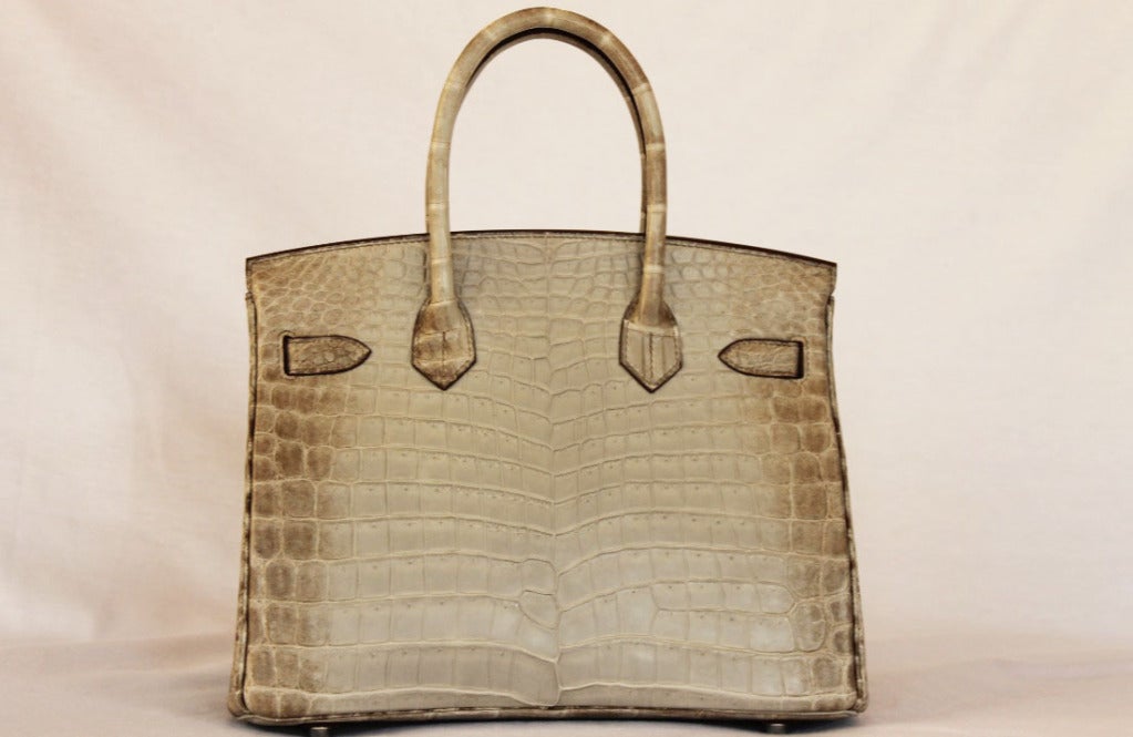 Authentic Hermès Birkin 30 Himalayan Cendre

This Hermes Birkin is in pristine condition.

No stains or marks or scratches on the exterior. Interior is odorless and stain free. Corners are intact and scuff free. Hardware is in perfect working