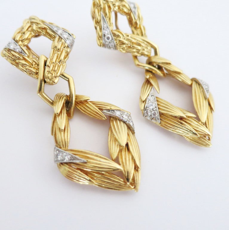 Designed as flexibly joined lozenge-shaped gold segments in a wheat sheaf pattern, with diamond-set accent segments mounted in white gold.  Diamonds weigh approximately 1.60 carats.