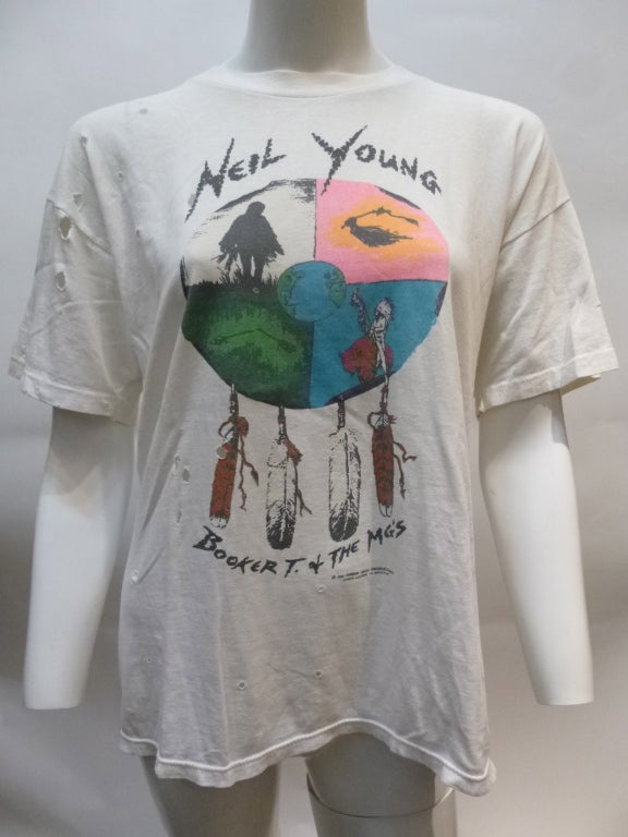 This is a promotional t-shirt for the 1993 World Tour of Neil Young + The MGs, with North American dates listed and a map of Europe of the back.


Stated size L. Bust: 22.5
