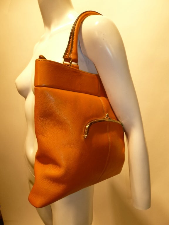 Bonnie Cashin joined Coach in 1963. She won her second Coty Award in 1968, a direct result of the line these bags come from. This is a deadstock (new-old/vintage unused) butter soft orange leather handbag. There is no hangtag, but it is from a lot