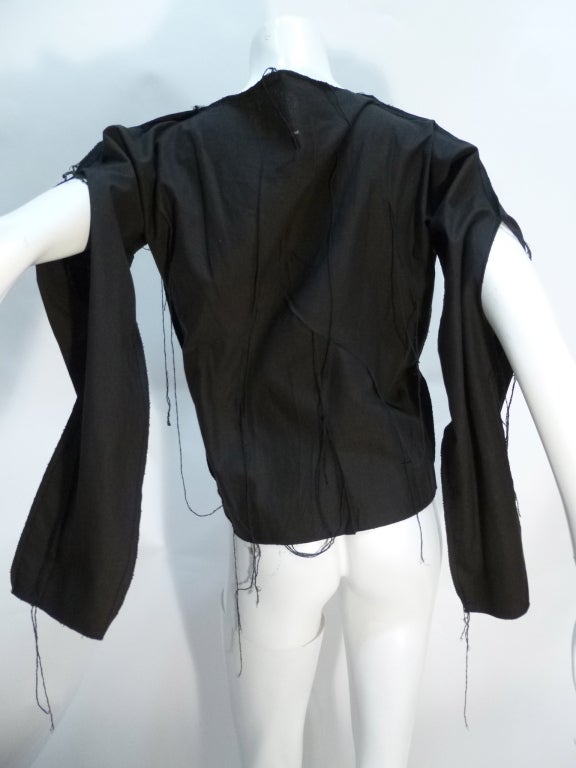 This is a late 1970s (possibly 1980) BOY Of London top. Interestingly constructed, with slits up the arm seams and many applied long strings hanging off of gathered tucks all over. Lovely and cool.

No stated size. Bust: 23