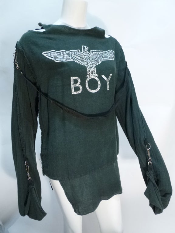 This is a BOY of London shirt from the late 1970s. The BOY logo, featuring the Nazi Parteiadler symbol. Clips allow the sleeves to be worn long or turned back up, attached with the D rings.

No stated size. Bust: 19