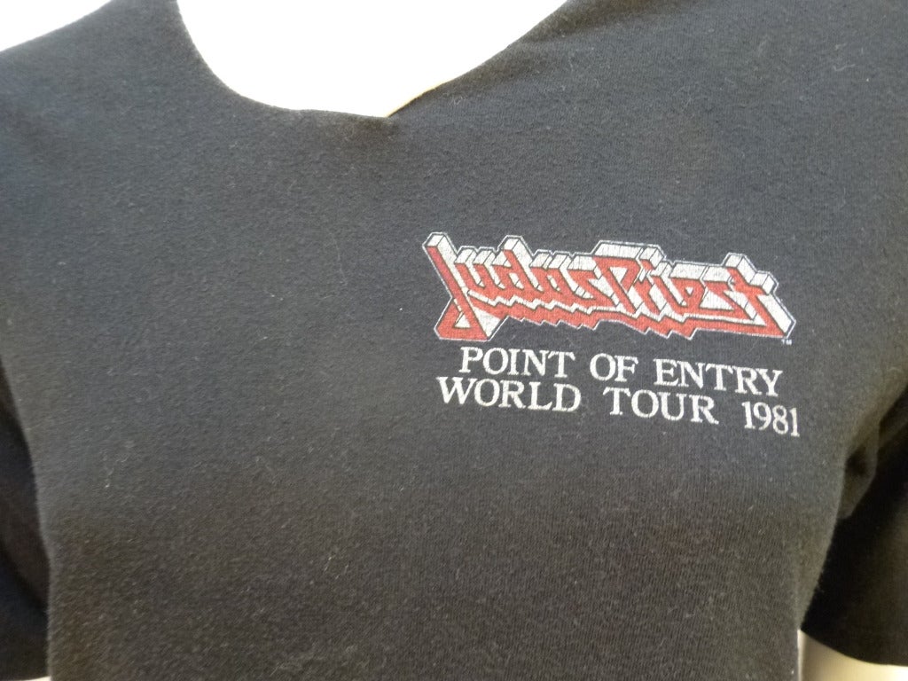 This T-shirt is a promotional V-necked ringer tee for the 1981 Point Of Entry Tour for influential British metal band Judas Priest. Rob Halford would be proud. 

Stated size XL 46. Bust: 19.5