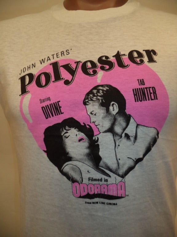 This is a promotional t-shirt from the 1981 film Polyester, starring Divine and Tab Hunter and directed by the inimitable John Waters. This is the one where cinemas handed out scratch and sniff cards to enhance the film-watching experience. 