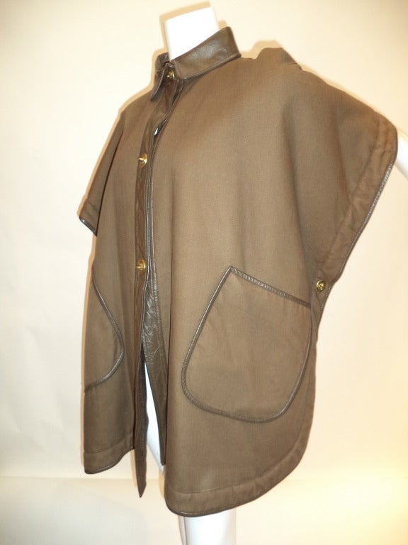 This very inventive jacket is from either late 60s or early 70s, judging by the detailing. See the last photo to see the coat untoggled and laid out flat - very unique design. Side toggles close the sides and the wearer's arms are placed between the