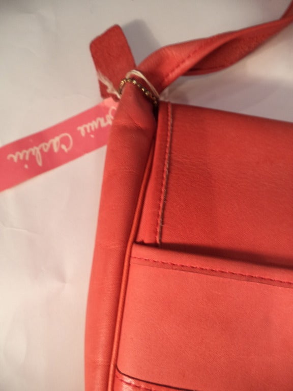 Bonnie Cashin joined Coach in 1963. She won her second Coty Award in 1968, a direct result of the line these bags come from. This is a deadstock (new-old/vintage unused) butter soft pinkish/orangish leather handbag. There is an original hangtag - it