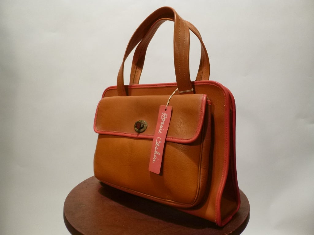 Bonnie Cashin joined Coach in 1963. She won her second Coty Award in 1968, a direct result of the line these bags come from - check our other listings to see some others. This is a deadstock (new-old/vintage unused) butter soft orange and pink