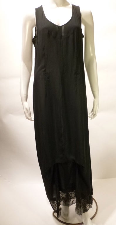Gorgeous avant garde Ann Demeulemeester sleeveless black dress with a beaded lace hem. There are no closures, zippers, or pockets. The darting and inner strapping give this beautiful garment a subtly altered form. It is meant to fit somewhat