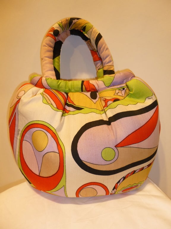 This is a vintage 1960s Pucci silk handbag with semi-rigid wiring in the stuffed handle so it stays upright and keeps its shape. It is lined in black and has a snap closure just inside. Interior is immaculate and the reinforced bottom shows no wear