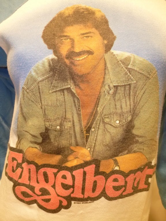Vintage promotional Engelbert Live In Concert portrait T-Shirt, dated 1984 on the front. Three-quarter sleeves, V-shaped hem. Winterland Productions tag.

Bust: 15.5