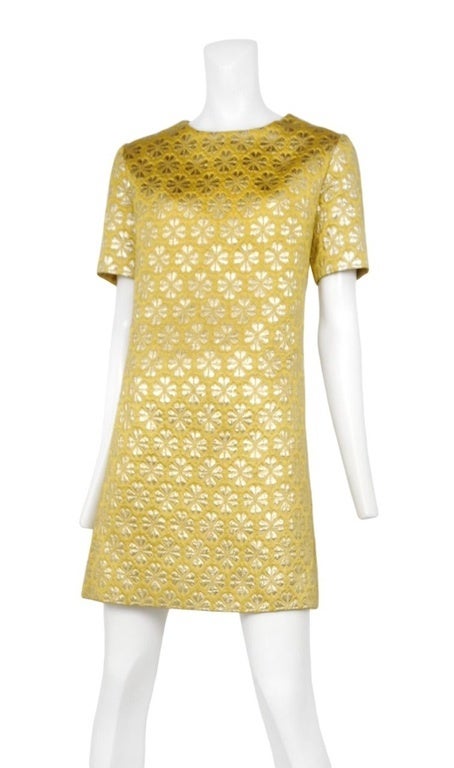 Yellow silk brocade shift dress with short cap sleeves and metallic clover print throughout. Back zip closure.