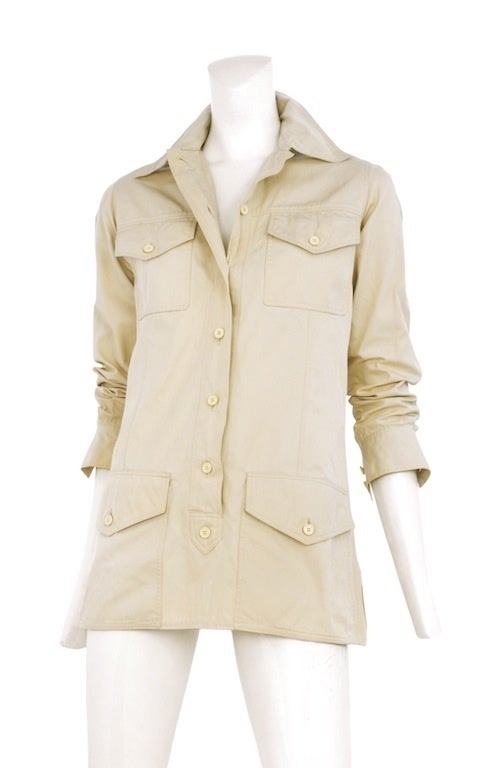 Khaki safari mini tunic with button front placket closure and four front patch pockets. Long sleeves with button cuff detail.
