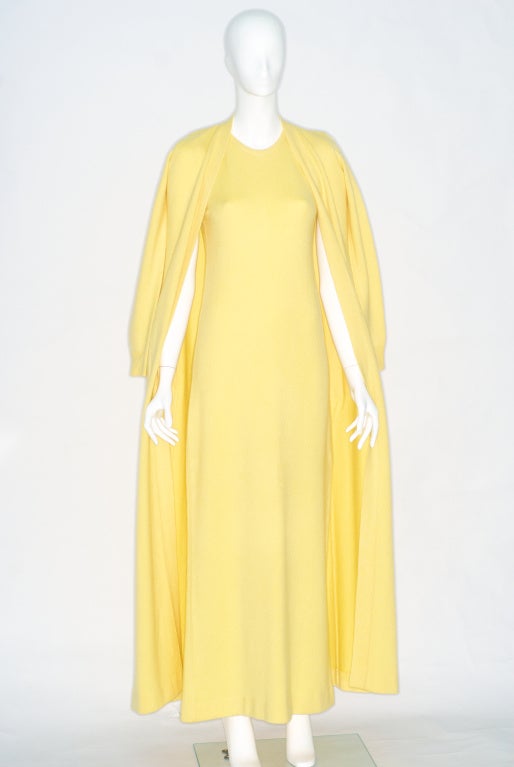 A signature Halston look for evening: The classic sweater set transformed into a long fitted gown for the evening with a matching long, high armhole, thin sleeved cardigan.

The myth of Halston is that of the glamor and decadence of the 1970s, of