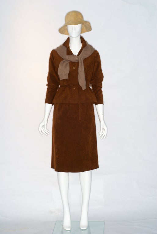 1970s Ultrasuede Halston ensemble composed of a button-down shirt with self belt  and relaxed fit skirt.  Please note the shirt and skirt are sold as an ensemble.  Hat, and cashmere sweater are sold separately.

Halston is practically synonomous