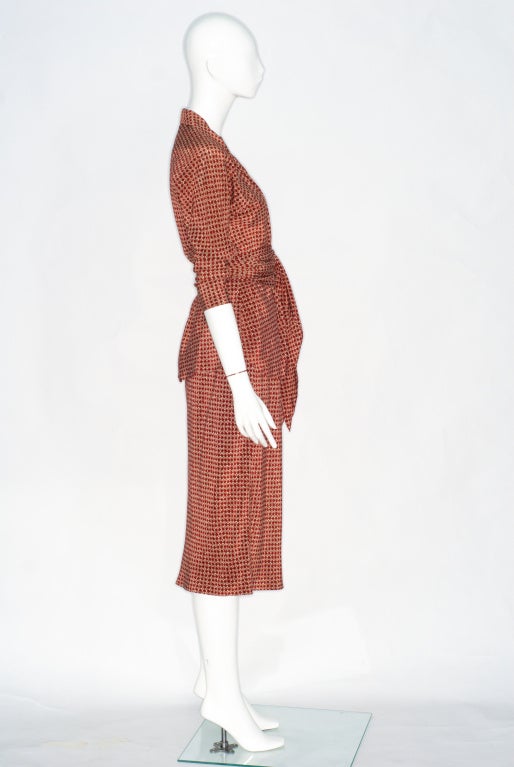 Halston Rust Colored Print Silk Wrap Blouse and Skirt.  Blouse has self belt and is cut on the bias as is the skirt which gently flares out at the hem but is softly fitted through the hips.  Please not e the hat and coat are sold separately. 