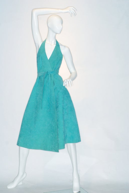 Turquoise Halston ultrasuede halter neck wrap dress.  

Halston is practically synonomous with ultrasuede.  Halston first saw the fabric on the Japanese designer Issey Miyake who was wearing a shirt jacket he had made of ultrasuede.

“I flipped”