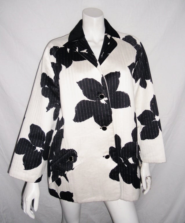 Velvet Collar, delicate silver straight stitch quilt  and beautiful large black flower print. Perfect jacket for mild weather.Black button front closure, two pockets with flap and buttons
