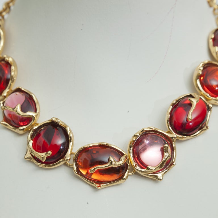 Pink, Orange and Fuhia-colored poured glass necklace gold plated metal.
Yves Saint Laurent made by Robert Goossens, circa 1980. 
 Excellent conditionMulti-color Cabochons of glass.