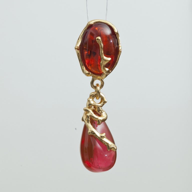 Exceptional Earrings of Yves Saint Laurent made by Robert Goossens, circa 1980. Red and Fushia Glass Cabochons. Gold plated metal. Marked YSL. Excellent condition. Size: 7x 3.5 cm - 3 1/2 x 1 2/5 in.