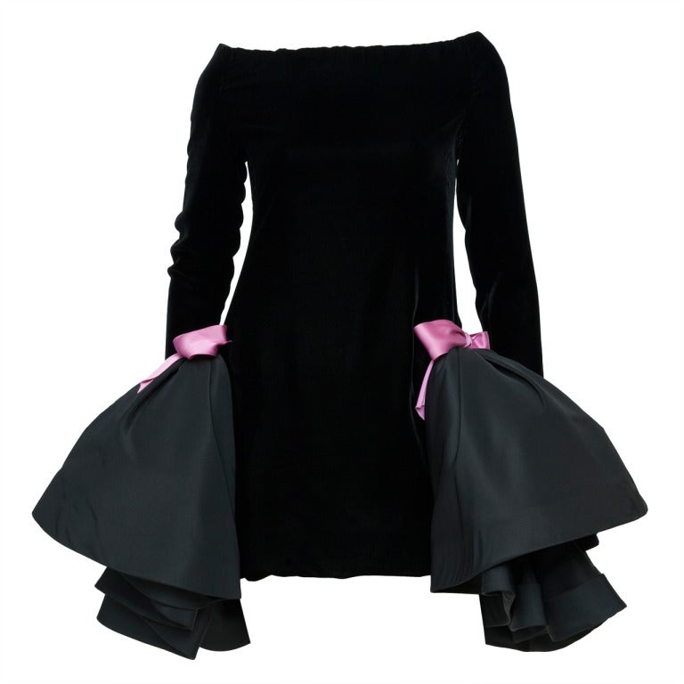 1980s Pierre Cardin Couture mini sheath black velvet dress with stylized side panniers and pink shocking silk ribbon knots