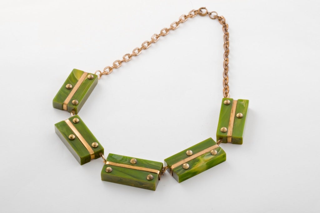 An Outstanding and Rare Art Deco Bakelite Demi Parure comprising a stunning Green Marbelized  Bakelite and Brass Bracelet with matching Necklace.