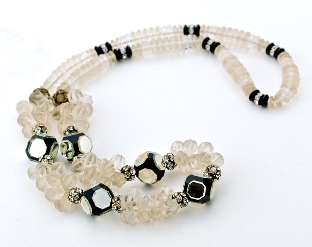 A Spectacular Art Deco Crystal and Onyx Sautoir necklace with frosted carved crystal beads accentuated by an assortment of mirrored onyx and carved onyx beads and dazzling pastes. In it's original gift box together with the presenters calling card. 