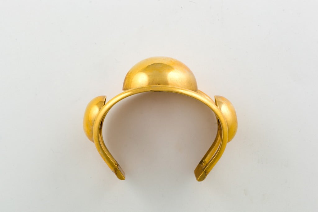 A large scale Machine Age gold tone cuff bangle with strong graphic detail. Unsigned.