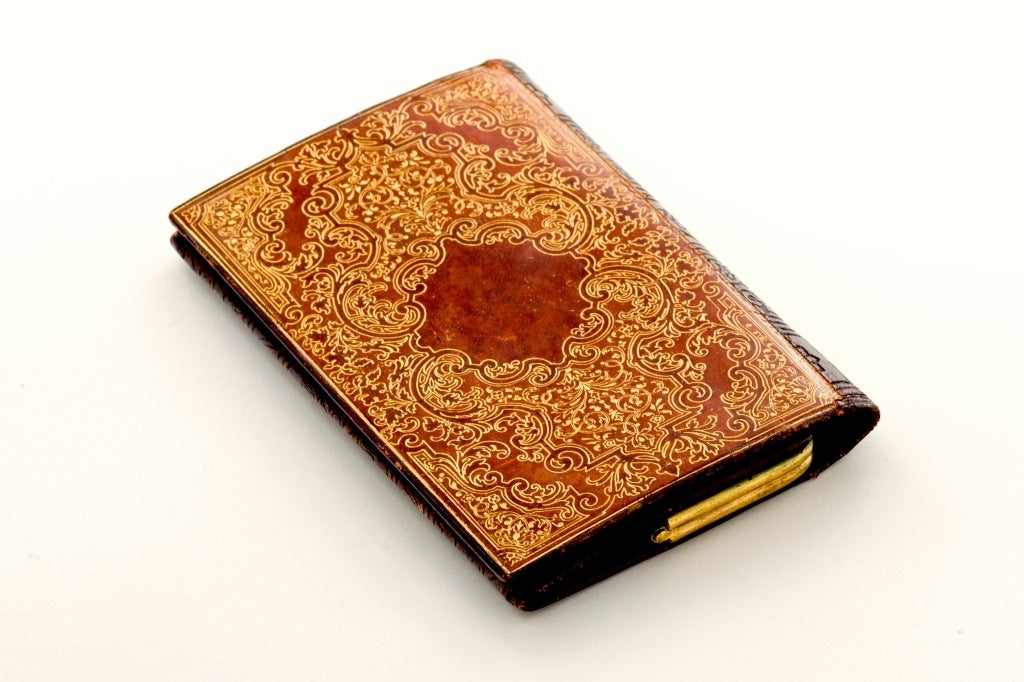 Fabulous Elaborately Tooled Leather Card Case by Lancel, Paris circa 1960's.  Glossy gold leaf and rust colored leather on front while back side is a glossy chocolate brown with a lime green silk lining. Signed. Striking!