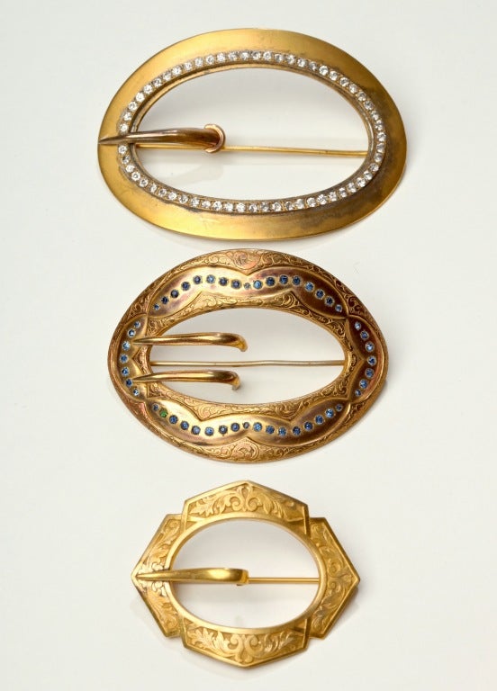 Wonderful selection of 3 Gilt Metal Victorian Sash Pins with Buckle motif. The largest with individually prong set white pastes measures 4