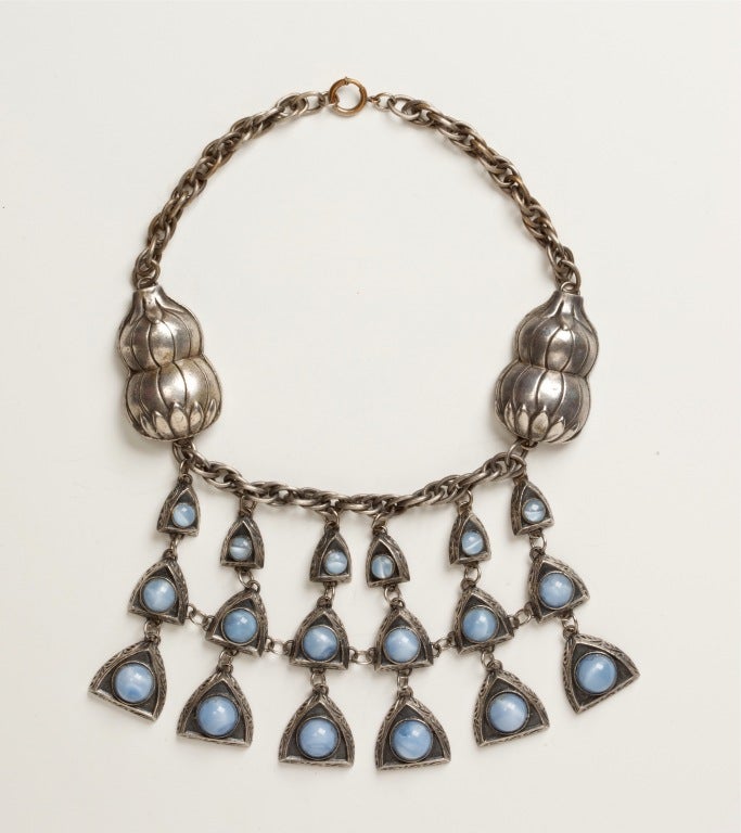 A rare Chanel Novelty Necklace by Reinad circa 1941 with a bold and striking design with cascading glass cabochons of faux moonstones.  Chanel Novelty was made in 1941 by Reinad during the war and stopped after Coco Chanel sued them for using her