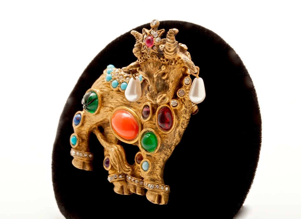 An Outstanding  Early K.J.L. Jewels of Fantasy Bull Brooch, this rare example in pristine condition. The Finely modeled gilt metal form studded with a sparkling erray of multicolored poured glass stones, diamante and  faux pearls, a stunning must