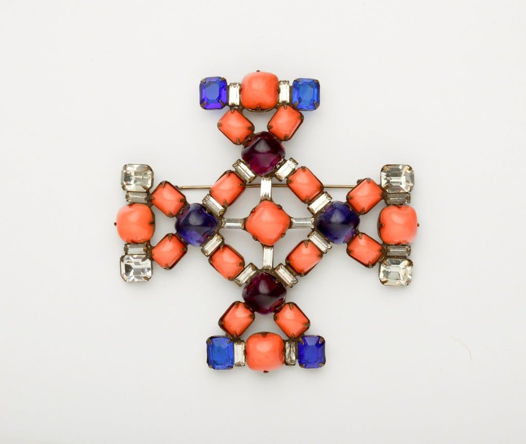 An early and rare KJL demi parure comprising a Maltese Cross brooch and matching earrings in exceptional colors. The brooch with alternating blue and purple prong-set glass cabochons amid faux-coral and rhinestones with some obvious conditions