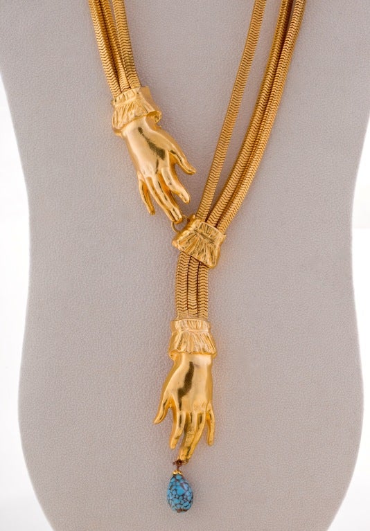 Fabulous Vintage Gilt Metal triple chain Necklace with a turquoise art glass drop on one hand and and slide on the other. Two smaller gilt hands are on the back side of the necklace.  Note some dark areas are camera reflections.  Attributed to